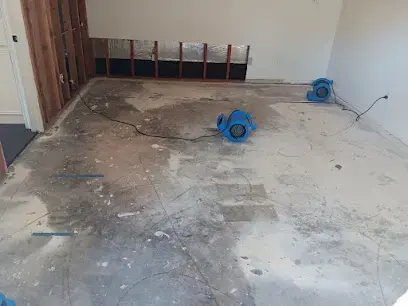 Air movers drying a basement room after the lower drywall was cut out